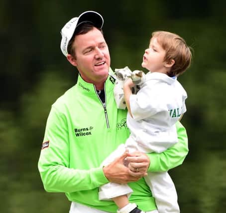 Jimmy Walker celebrates with his son after winning the Par 3 Contest. Picture: Getty Images