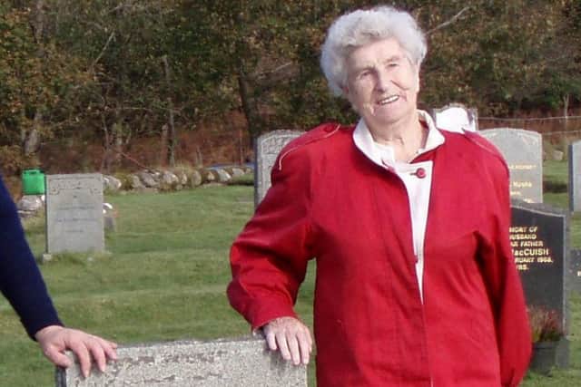 Former St Kilda resident Rachel Johnson at the grave of her parents Donald and Cristina Gillies.