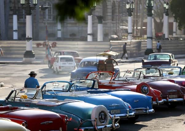 For now Cubas roads are still filled with vintage American cars, but tourism from America is starting to build up. Picture: Getty Images