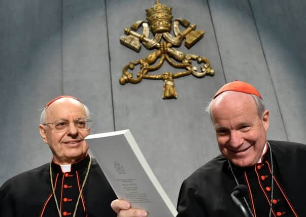 Cardinal Lorenzo Baldisseri, left, and Cardinal Christoph Schonborn with a copy of the the Popes document, the Amoris Laetitia. Picture: AFP/Getty Images