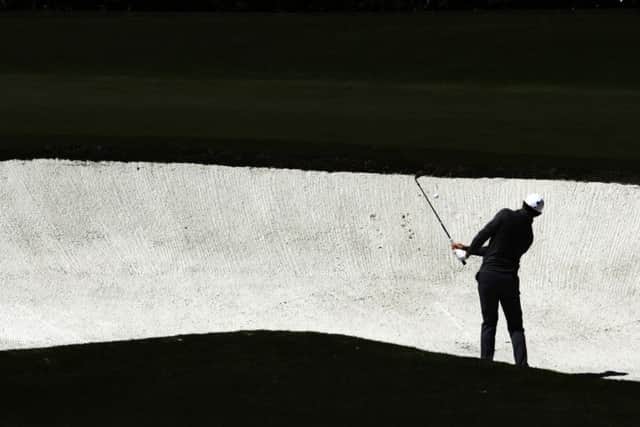 Rory McIlroy hits from a bunker on the fourth hole during the second round of the Masters. Picture:  Charlie Riedel/AP Photo