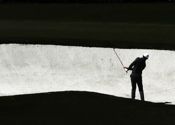 Rory McIlroy hits from a bunker on the fourth hole during the second round of the Masters. Picture:  Charlie Riedel/AP Photo