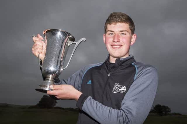 Eric McIntosh lifts the cup after defeating Lewis Irvine 2&1. Photograph: Kenny Smith