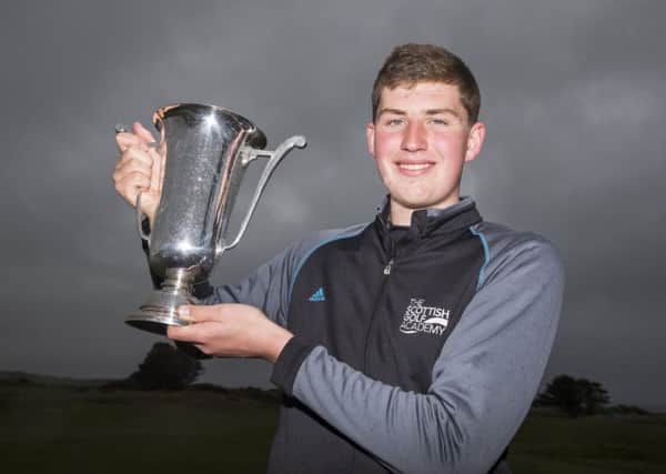 Eric McIntosh lifts the cup after defeating Lewis Irvine 2&1.  Photograph: Kenny Smith