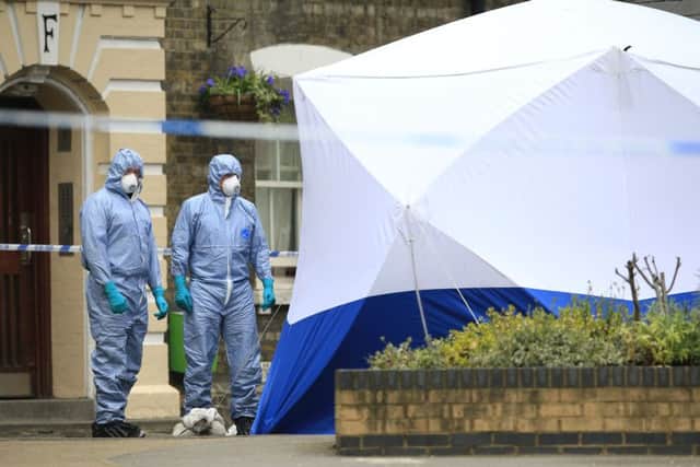 Police forensic officers at the property where the remains of Pc Gordon Semple, 59, were found. Picture: PA
