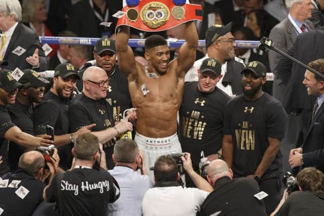 Anthony Joshua raises the IBF heavyweight belt. Picture: William Hill/PA.
