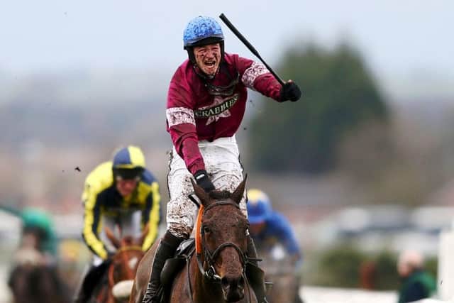 Jockey David Mullins celebrates after riding Rule the world to victory in the Grand National. Picture: Getty