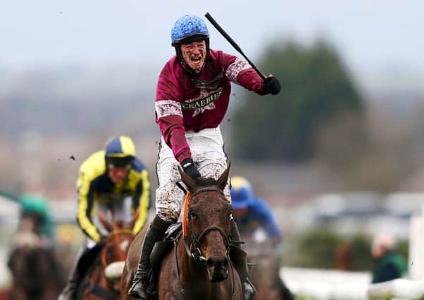 Jockey David Mullins celebrates after riding Rule the world to victory in the Grand National. Picture: Getty