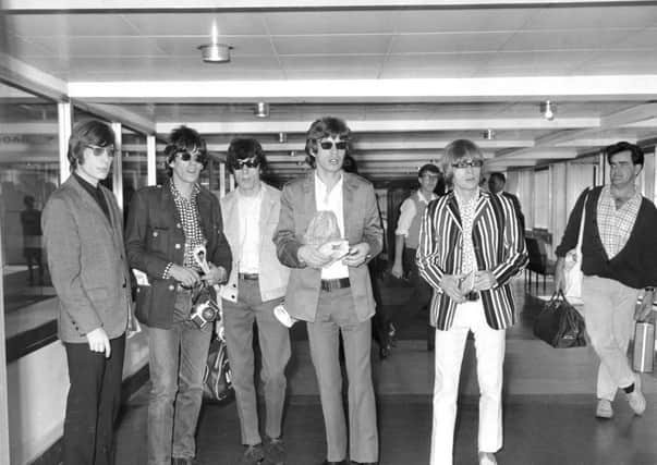 Ian Stewart, far right, was declared not to look right for the rest of the band, from left:  Charlie Watts, Keith Richards, Bill Wyman, Mick Jagger, and Brian Jones  at London airport in 1966. Picture: Getty