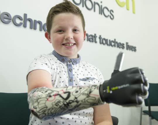 Nine-year-old Josh Cathcart, who was born with his right arm missing from the elbow down is the first person in the UK to be fitted with Touch Bionics' new bionic hand. Josh was at Touch Bionics, Oakbank, Livingston to complete his fitting with the i-limb quantum.  Picture Ian Rutherford