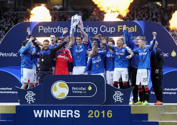 Rangers players celebrate after lifting the Petrofac Training Cup. Picture: Michael Gillen