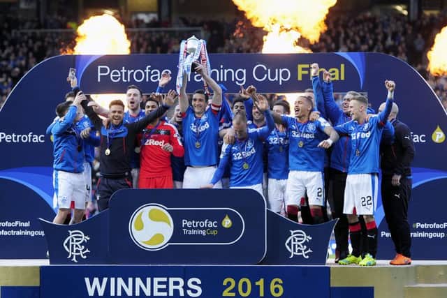 Rangers players celebrate after lifting the Petrofac Training Cup. Picture: Michael Gillen