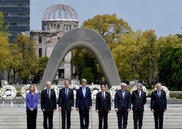 From left, G7 foreign ministers the EUs Federica Mogherini, Canadas Stephane Dion, Westminsters Philip Hammond, John Kerry, Japans Fumio Kishida, Germanys Frank-Walter Steinmeier, Italys Paolo Gentiloni and Frances Jean-Marc Ayrault pose after laying a wreath at the Memorial Cenotaph in Hiroshima. Picture: Getty