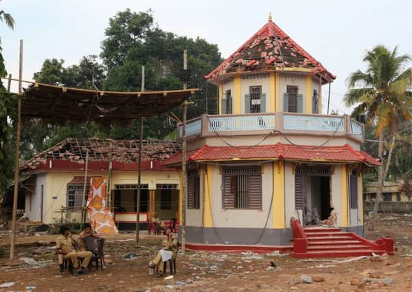 Policemen on duty at Puttingal Temple in Paravoor village, Kerula, where a fire killed 110 people at a religious festival. Picture: AP