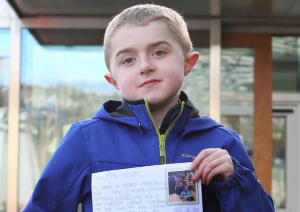 Nine year old Michael Young from Larbert near Falkirk outside the Scottish Parliament as he prepares to deliver a letter to First Minister Nicola Sturgeon at the Scottish Parliament Edinburgh, calling for NHS access to medication.  It is thought that Michael Young is one of five children in Scotland that could benefit from Translarna, the first drug for an underlying cause of muscular dystrophy to be approved in the EU.