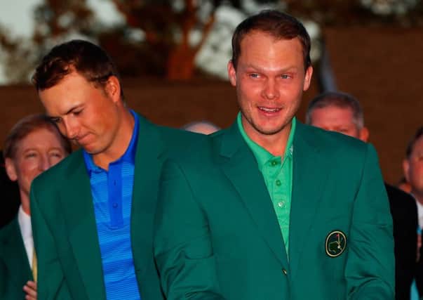 Outgoing champion Jordan Spieth presents Danny Willett with his Green Jacket. Picture: Getty