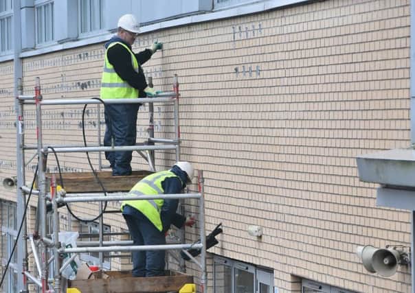 Workmen carry out repairs at Oxgangs Primary School. Picture: Getty