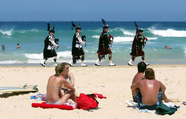 Soldiers from the Scots Royal Dragoon Guards and 1st Battalion The Highlanders entertain bathers at Sydney's Bondi Beach. Picture: PA