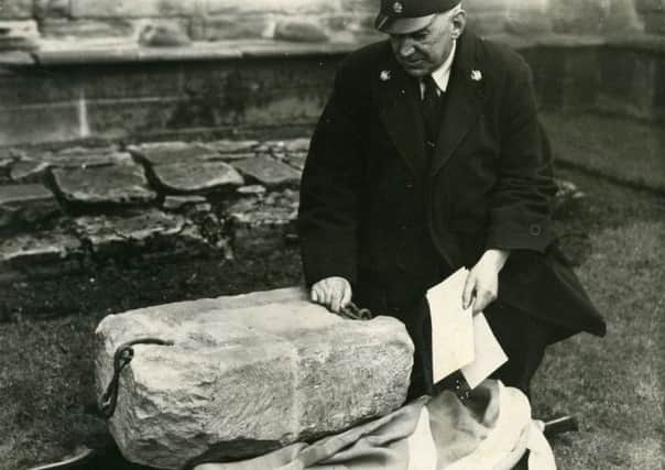 This is the very first picture taken of the Stone of Destiny when it was returned to Arbroath Abbey in April 1951, three months after its disappearance from Westminster Abbey, with custodian of the Abbey James Wishart. Picture: Arthur Binnie