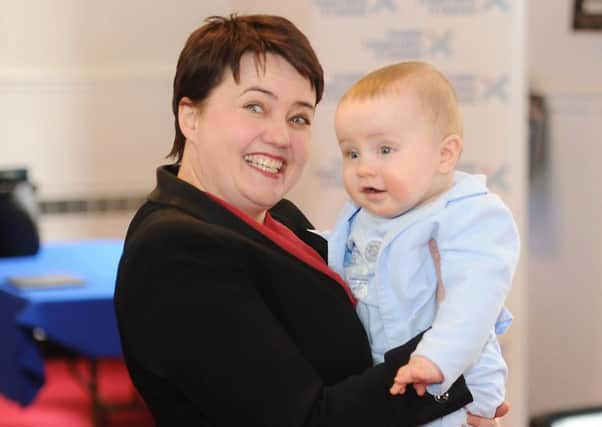 Ruth Davidson makes a new friend  on the campaign trail in Glasgow. Picture: John Devlin