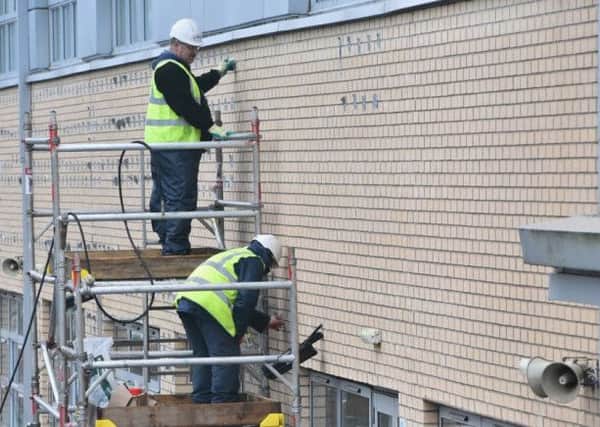 Workmen carry out repairs at Oxgangs Primary School. Picture: Getty