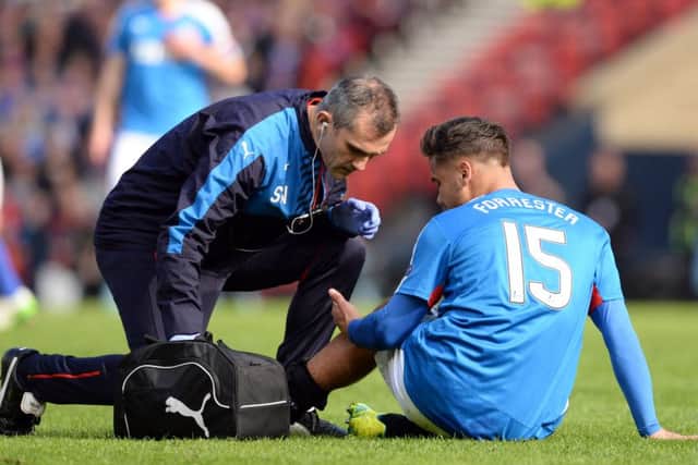Rangers' Harry Forrester receives treatment during the Petrofac Training Cup final. Picture: SNS