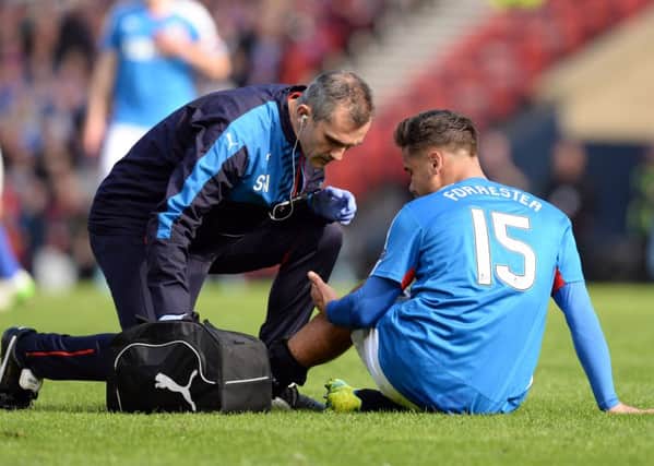Rangers' Harry Forrester receives treatment during the Petrofac Training Cup final. Picture: SNS