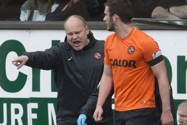 Dundee United manager Mixu Paatelainen tells Gavin Gunning to go back on to the field for treatment following the bizarre incident. Picture: SNS