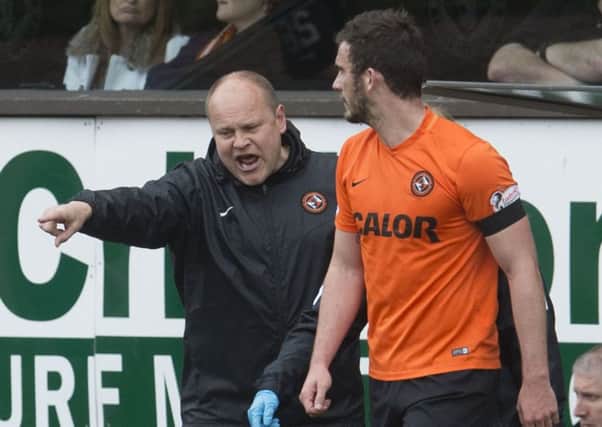 Dundee United manager Mixu Paatelainen tells Gavin Gunning to go back on to the field for treatment following the bizarre incident. Picture: SNS