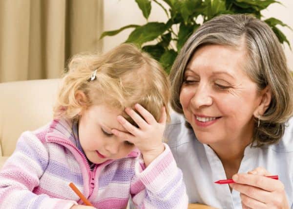 Grandmother and granddaughter drawing together with pencils at home. Picture: Candybox