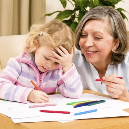Grandmother and granddaughter drawing together with pencils at home. Picture: Candybox