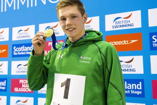 Duncan Scott collects his gold medal after the men's 100m freestyle. Picture: Craig Foy/SNS