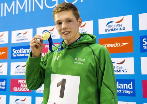 Duncan Scott collects his gold medal after the men's 100m freestyle. Picture: Craig Foy/SNS