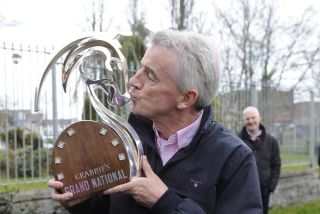 Owner Michael O'Leary kisses the Crabbie's Grand National trophy after Rule The World's victory. Picture: PA Wire