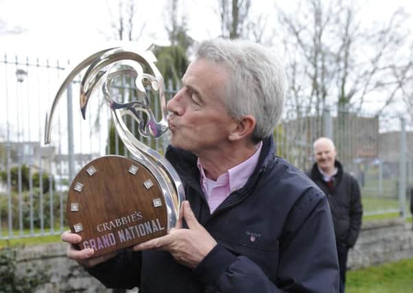 Owner Michael O'Leary kisses the Crabbie's Grand National trophy after Rule The World's victory. Picture: PA Wire