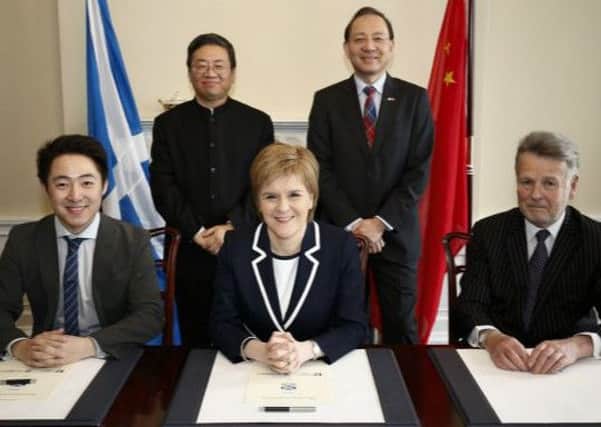 Nicola Sturgeon signed a  memorandum with Zhang Yu, left, of SinoFortone and Sir Richard Heygate, right. Picture: China Daily