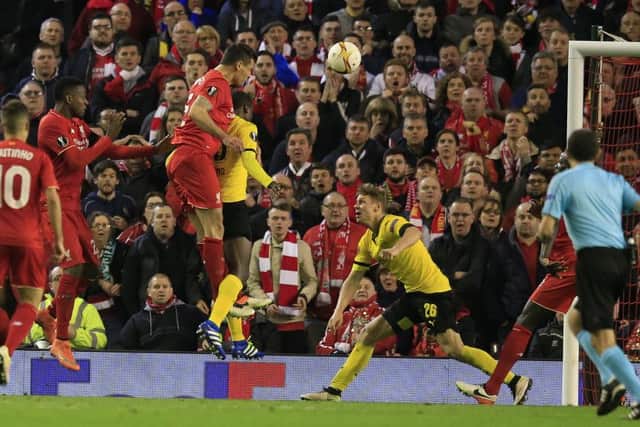 Dejan Lovren rises highest to head Liverpools dramatic, injury-time winner against Borussia Dortmund last night. Picture: AP