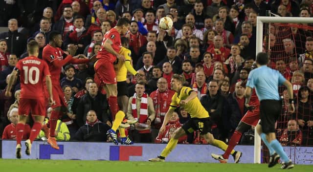 Dejan Lovren rises highest to head Liverpools dramatic, injury-time winner against Borussia Dortmund last night. Picture: AP