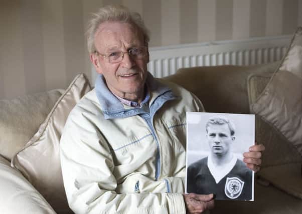 Former Rangers and Scotland winger Davie Wilson at home in Glasgow with a picture of himself in his Scotland shirt. Picture Ian Rutherford