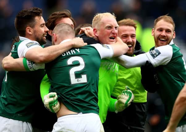 Conrad Logan of Hibernian is mobbed by teammates after winning the Scottish Cup semi-final. Picture: Getty Images