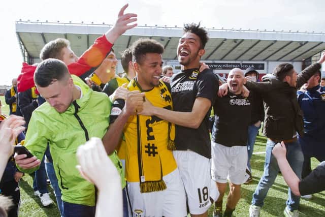 Nathan Austin celebrates with brother Jordan following East Fife's title win.