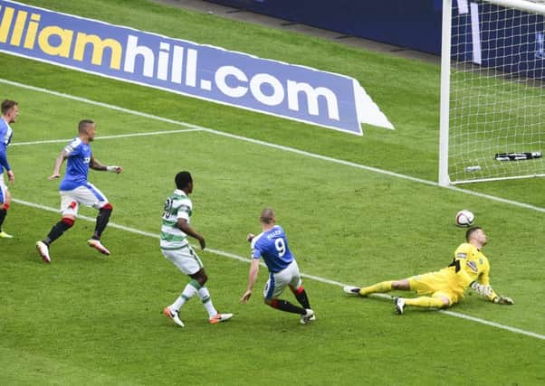 Miller clips the ball past Craig Gordon after Scott Brown had deflected the ball into his path. Picture: SNS Group