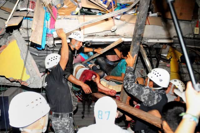 Rescuers dig survivors out of a collapsed building in Manta, which suffered despite being several hundred miles from the epicentre. Picture: Getty Images