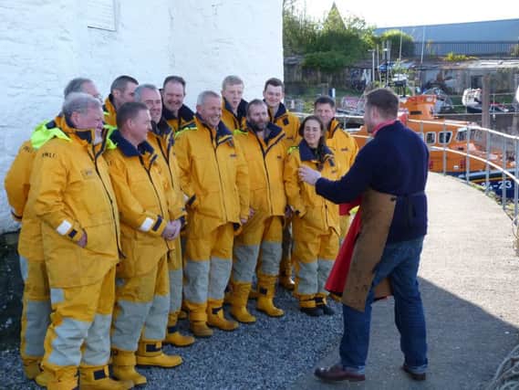 Jack Lowe organises the Oban lifeboat crew in preparation for their photograph. Picture: Moira Kerr