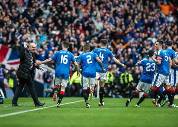 Rangers manager Mark Warburton, left, celebrates with his players at Hampden. Picture: John Devlin