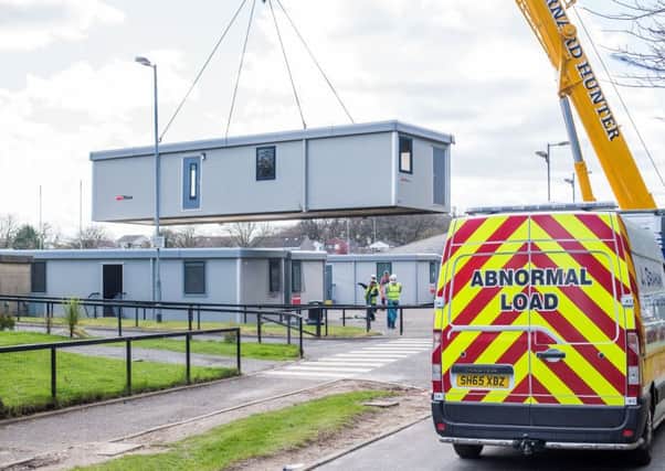Temporary classrooms are moved into place at the Royal High School in Edinburgh. Picture: Ian Georgeson