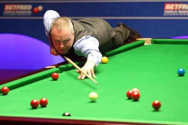John Higgins in action against Ryan Day at the Betfred Snooker World Championships at the Crucible. Picture: Martin Rickett/PA
