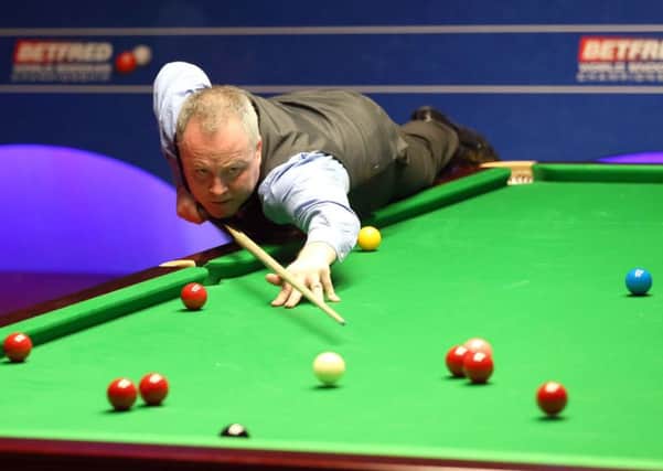 John Higgins in action against Ryan Day at the Betfred Snooker World Championships at the Crucible. Picture: Martin Rickett/PA
