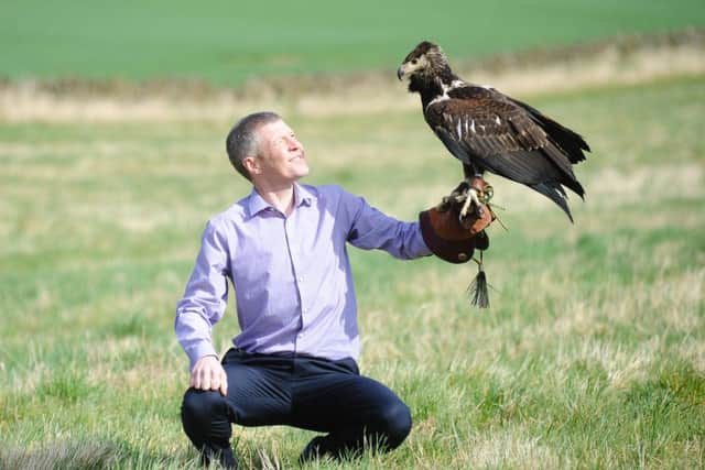 Willie Rennie with a bird of prey on the campaign trail.