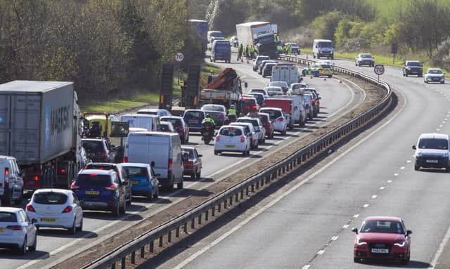 TNT lorry mounts the central reservation at Calder Junction of the Edinburgh City Bypass causing chaotic rush hour traffic. Pictures: SWNS